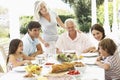 Three Generation Family Enjoying Meal Outdoors Royalty Free Stock Photo