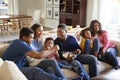 Three generation family African American  family sitting on the sofa in living room, watching TV and eating popcorn together, elev Royalty Free Stock Photo