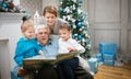 Three generation family reading a book Royalty Free Stock Photo