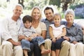 Three Generation Family Sitting On Sofa At Home Royalty Free Stock Photo