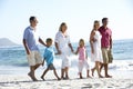 Three Generation Family Walking Along Sandy Beach Royalty Free Stock Photo