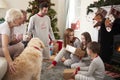 Three Generation Family Wearing Pajamas In Lounge At Home Opening Gifts On Christmas Day Royalty Free Stock Photo