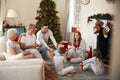 Three Generation Family Wearing Pajamas In Lounge At Home Opening Gifts On Christmas Day Royalty Free Stock Photo