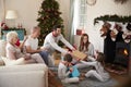 Three Generation Family Wearing Pajamas In Lounge At Home Opening Gifts On Christmas Day Royalty Free Stock Photo