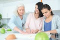 Three generation women making apple pie Royalty Free Stock Photo