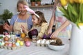 Three generation of women preparation natural dyes for coloring eggs