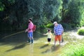 Three generations ages: grandfather, father and young teenager son. Old and young. Dad and son fishing at lake. Royalty Free Stock Photo