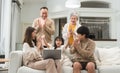 Three generations of Asian family, grandmother, grandfather, father, mother, little cute daughter using laptop, relaxing together Royalty Free Stock Photo