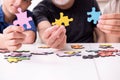 Three generations of family playing jigsaw puzzle game Royalty Free Stock Photo
