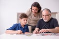 Three generations of family playing jigsaw puzzle game