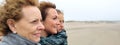 Three generations female looking at sea