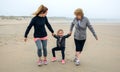 Three generations female running on the beach