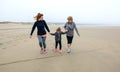 Three generations female running on the beach