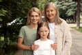 Three generations. Happy grandmother, her daughter and granddaughter outdoors