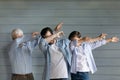 Three generations of men have fun dab dancing