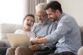 Three generations of men relax at home with laptop Royalty Free Stock Photo