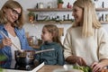 Happy three generations women cooking in the kitchen