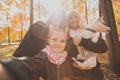Three generations of women and dog feel fun look at camera posing for self-portrait picture together, funny excited Royalty Free Stock Photo
