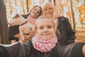 Three generations of women and dog feel fun look at camera posing for self-portrait picture together, funny excited Royalty Free Stock Photo