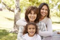 Three generations of women at a family picnic in a park Royalty Free Stock Photo