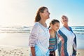 Three generations of women. a senior woman spending the day at the beach with her daughter and granddaughter. Royalty Free Stock Photo