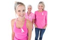 Three generations of women wearing pink tops and breast cancer r