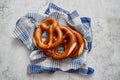 Three german fresh baked pretzel buns placed on napkin