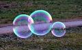 Three giant bubbles floating in the air