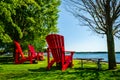 Three giant red adirondack chairs at Brockville`s St. Lawrence River waterfront