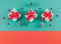 Three gift boxes with Christmas decor on green and red. Royalty Free Stock Photo