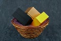 Three gift boxes of different colors in a wicker basket Royalty Free Stock Photo
