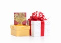 Three gift boxes tied with colored satin ribbons bow on white Royalty Free Stock Photo