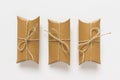 Three gifts made of craft paper wrapped with packthread Royalty Free Stock Photo