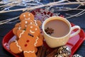 White branches three Gingerbread men top view with coffee on red dish Royalty Free Stock Photo