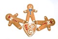 Three gingerbread men with a cookie heart isolated