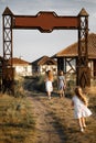 Three girl coming out of the gate of the village