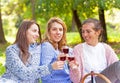 Three girlfriends drinking wine