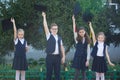 Three girls and a boy are elementary school graduates in a graduate hat Royalty Free Stock Photo