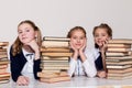 Three girls in the classroom studying many books Royalty Free Stock Photo