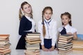 Three girls in the classroom studying many books Royalty Free Stock Photo