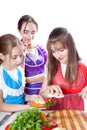 Three girls of the cook prepare a vegetarian dish Royalty Free Stock Photo