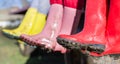 Three girls in dirty gumboots Royalty Free Stock Photo