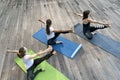 Three girls do yoga on outside. Morning yoga practice. Outdoor fitness. Healthy lifestyle Royalty Free Stock Photo