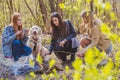 Three girls with a dog are resting in the forest Royalty Free Stock Photo