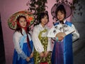 Three girls dressed in hanbok, traditional Korean dress on a street in Seoul