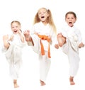 Three girls dressed in white kimono perform punch Royalty Free Stock Photo