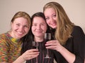 Three girls drinks wine