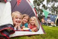 Three Girls Enjoying Camping Holiday On Campsite Royalty Free Stock Photo