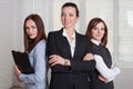 Three girls in formal clothes are of different heights