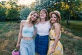 Three of girls friends outdoor in the park or forest